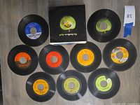 Group shot of all ten singles with Apple company sleeve visible
