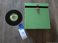 Green record storage case with one 7-inch vinyl record