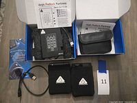 Overall lot with both boxed drives, sleeves, cable, pouch and guide visible