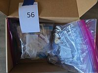 Box containing zip-lock bags of coins and banknotes