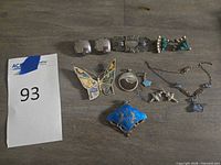 Full lot view showing all 11 jewelry pieces on table