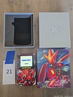 Game Boy Color console, custom box, grey slipcase and foam insert displayed on table