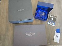Two Waterford presentation boxes, blue gift box with heart ornament and booklet visible