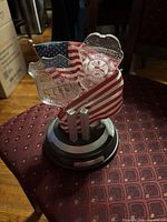 Front view showing badges, flag and twin towers on base