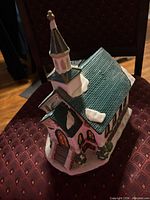 Front angled view showing steeple, windows, snow accents