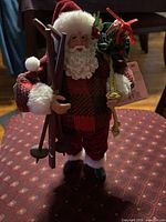 Front view of Santa figurine showing skis, poles and attire