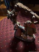 Front view showing Mary, Joseph, Baby Jesus, lamb and stable roof