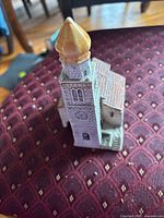 Front angled view showing tower, roof detail, overall colour