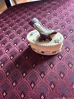 Trinket box closed showing boot lid and side motifs