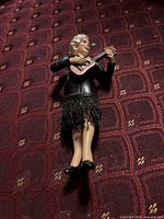 Full view of figurine front on patterned background