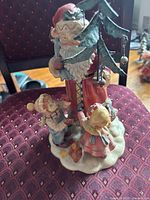 Front view of Santa figurine with children and tree