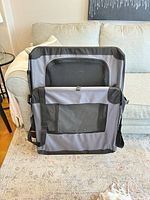 Front view of folded gray/black ARF PETS soft crate showing mesh window and carry strap