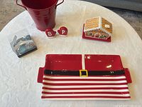 Group shot showing all items: tray, gingerbread house dish, salt & pepper shakers, red bucket, boxed ornaments