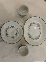 Two plates, platter partially visible, and two ramekins displayed