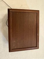 Closed brown wood box housing telephone