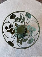 Top view showing open scrollwork bowl with rose and leaf motifs