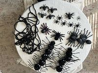 Top-down view showing full assortment of spiders and garland on white surface
