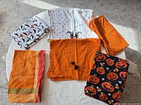Six assorted Halloween towels spread out showing patterns