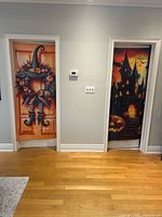 Both Halloween door covers hung on doors