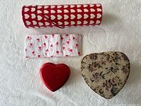 Group shot showing metal tin, fabric box, gift tube, tissue sheet