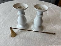 pair of porcelain candlesticks with brass snuffer