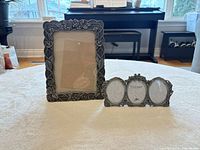 Front view of both pewter frames showing design and size comparison