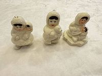 Front view of all three Inuit chalkware figurines