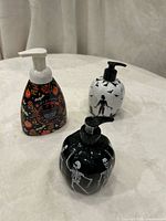 All three Halloween soap dispensers showing designs and pump tops