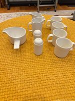 Front angled view showing all nine white ribbed ceramic pieces