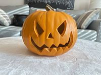 Front view of foam jack-o-lantern showing carved face