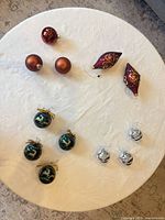 All 13 ornaments laid out on table showing variety and count