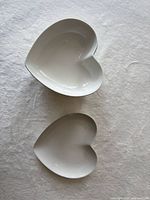 Top view of one bowl and plate showing heart shape and white glaze