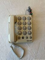 Front view showing handset, keypad, cords