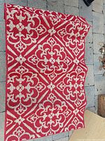 Entire rug showing red and beige medallion/floral/geometric pattern