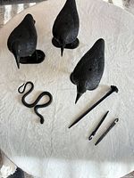 Three crow decoys, two long stakes, one mounting piece, snake prop on tabletop