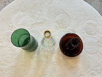 Top view of three glass pieces showing shapes and openings