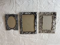 Front view of three metal picture frames showing style, openings and finishes