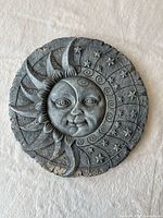 Front view of round sun & moon concrete plaque