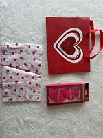 Overview showing gift bag, folded tissue sheets and boxed makeup puffs