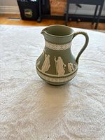 Three-quarter view showing full pitcher and relief decoration