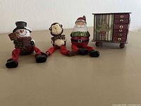 Front view of all items: Advent chest, snowman, monkey, Santa