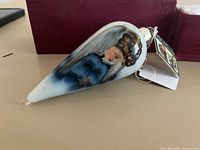 Side view showing angel portrait and teardrop shape