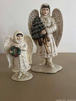 Both resin crackle-finish angel figurines positioned side by side