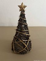 Full view of gold-painted grapevine tree with spiral wrap, beads, star topper