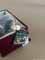 Ornament in original maroon box with Old World Christmas hang tag visible