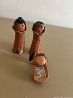 Bottom of figurine showing handcrafted clay and label