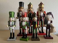 Group of seven painted wooden nutcracker figurines in two height ranges