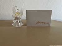 Clear plastic angel figurine with accompanying branded box