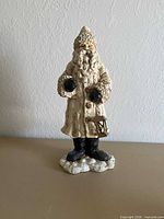 Full view of ivory resin Santa figurine on base