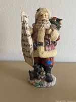 Front view of resin Santa figurine with accessories